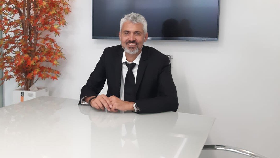 Adv. Shay Zohar in his office, by the conference table