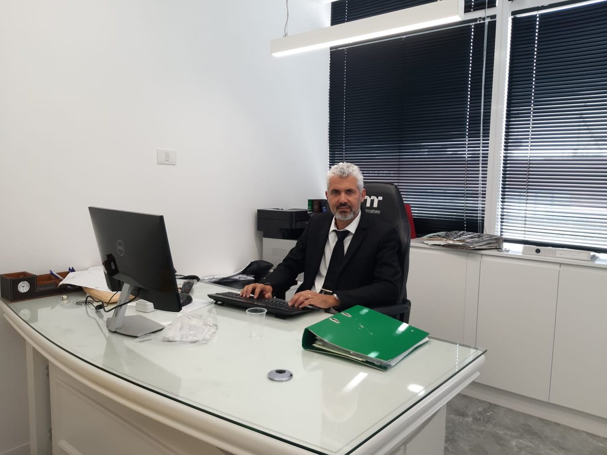 Adv. Shay Zohar at the desk in the office